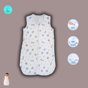 A smiling baby lies on a soft beige blanket wearing a lightweight white muslin sleeping bag with a front zipper and a small blue-and-beige safari animal print featuring lions, giraffes, elephants, monkeys, stars, and "zoo" text. The sleeveless sleeping bag has a slim, straight silhouette with a rounded bottom, while the baby's arms rest comfortably at the sides in a bright, softly lit overhead photograph.