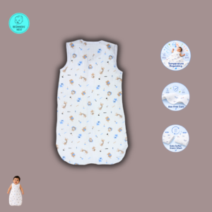 A smiling baby lies on a soft beige blanket wearing a lightweight white muslin sleeping bag with a front zipper and a small blue-and-beige safari animal print featuring lions, giraffes, elephants, monkeys, stars, and "zoo" text. The sleeveless sleeping bag has a slim, straight silhouette with a rounded bottom, while the baby's arms rest comfortably at the sides in a bright, softly lit overhead photograph.