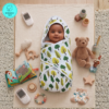 Indian looking baby Wrapped in Muslin Hooded towel. The Muslin hooded towel has little green trees print
