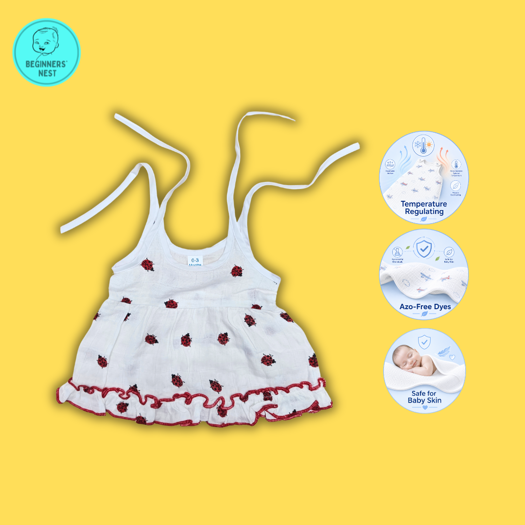 3 Small Baby girl wearing a muslin frock with Red Lady bug prints on it. Soft and Breathable. Azo-free dye. Gets softer every wash