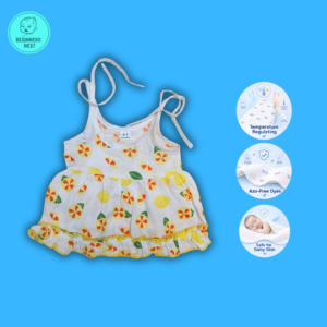 Small Baby girl wearing a muslin frock with Yellow- sliced lemon prints on it. Soft and Breathable. Azo-free dye. Gets softer every wash