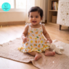 Small Baby girl wearing a muslin frock with Yellow- sliced lemon prints on it. Soft and Breathable. Azo-free dye. Gets softer every wash